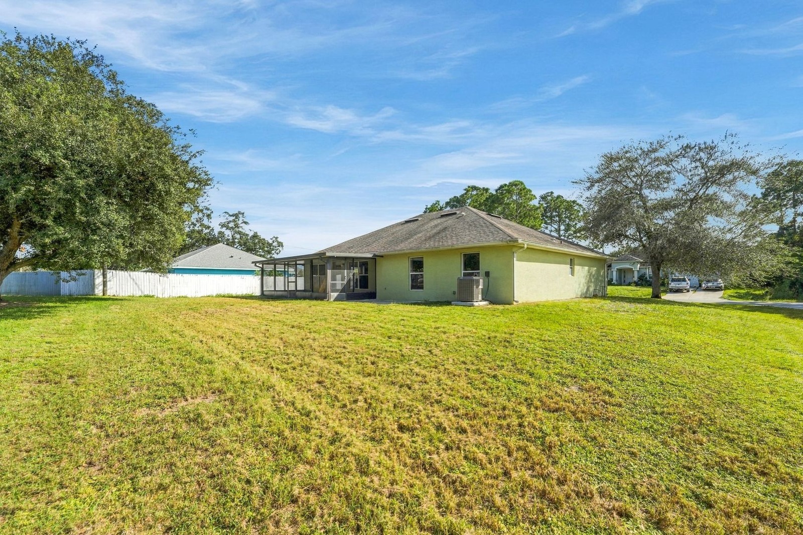 Wide backyard with mature shade trees at 707 Merrimac St SE