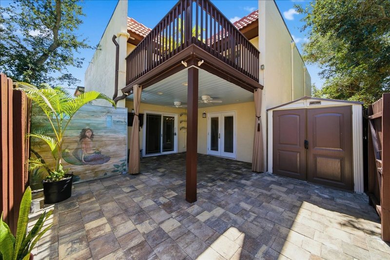 Private paver patio, outdoor shower, and entry of 8760 Live Oak Ct, a remodeled beachside townhome in Ocean Woods, Cape Canaveral FL 32920