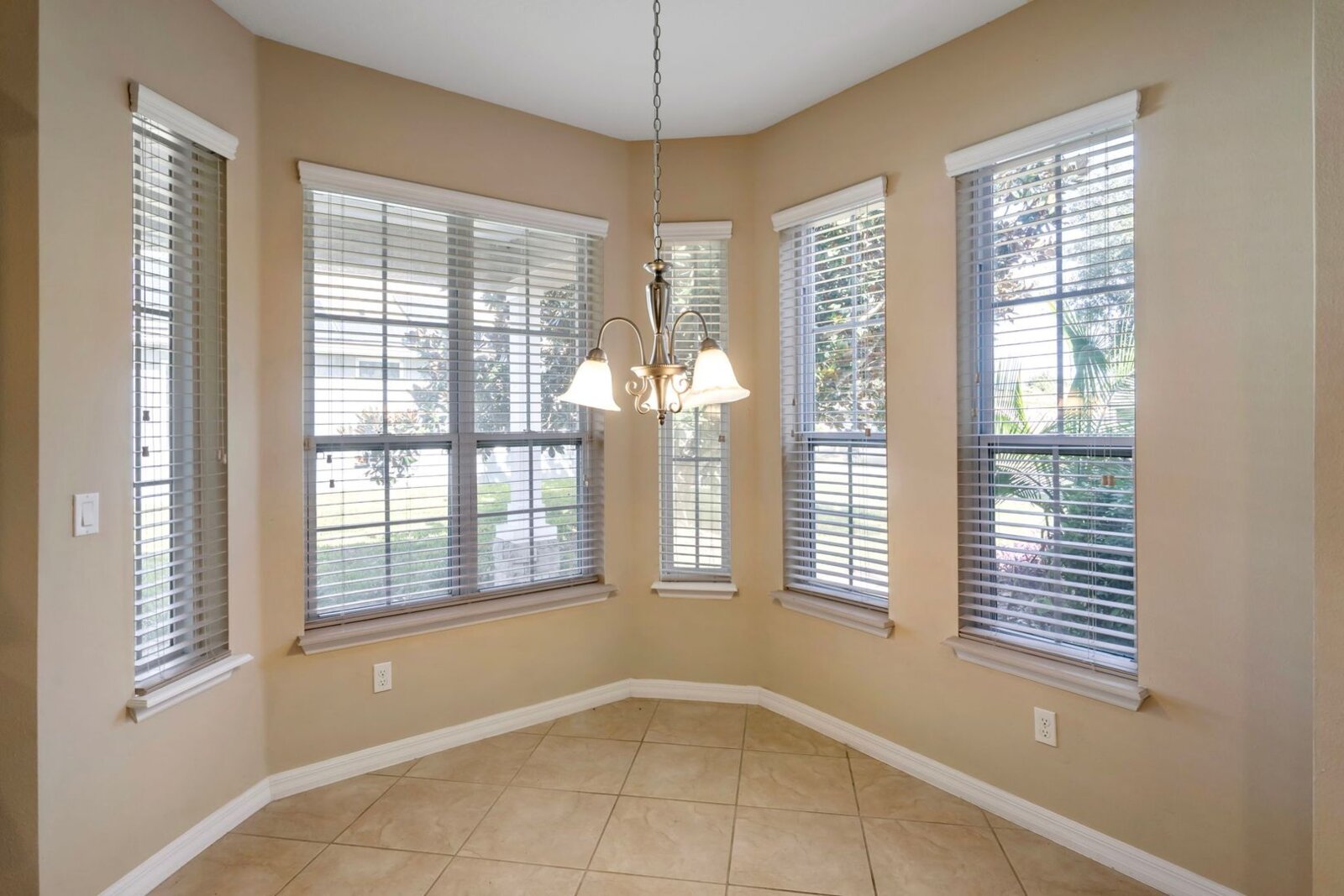 Breakfast nook with bay window and chandelier at 374 Salt Marsh Ln