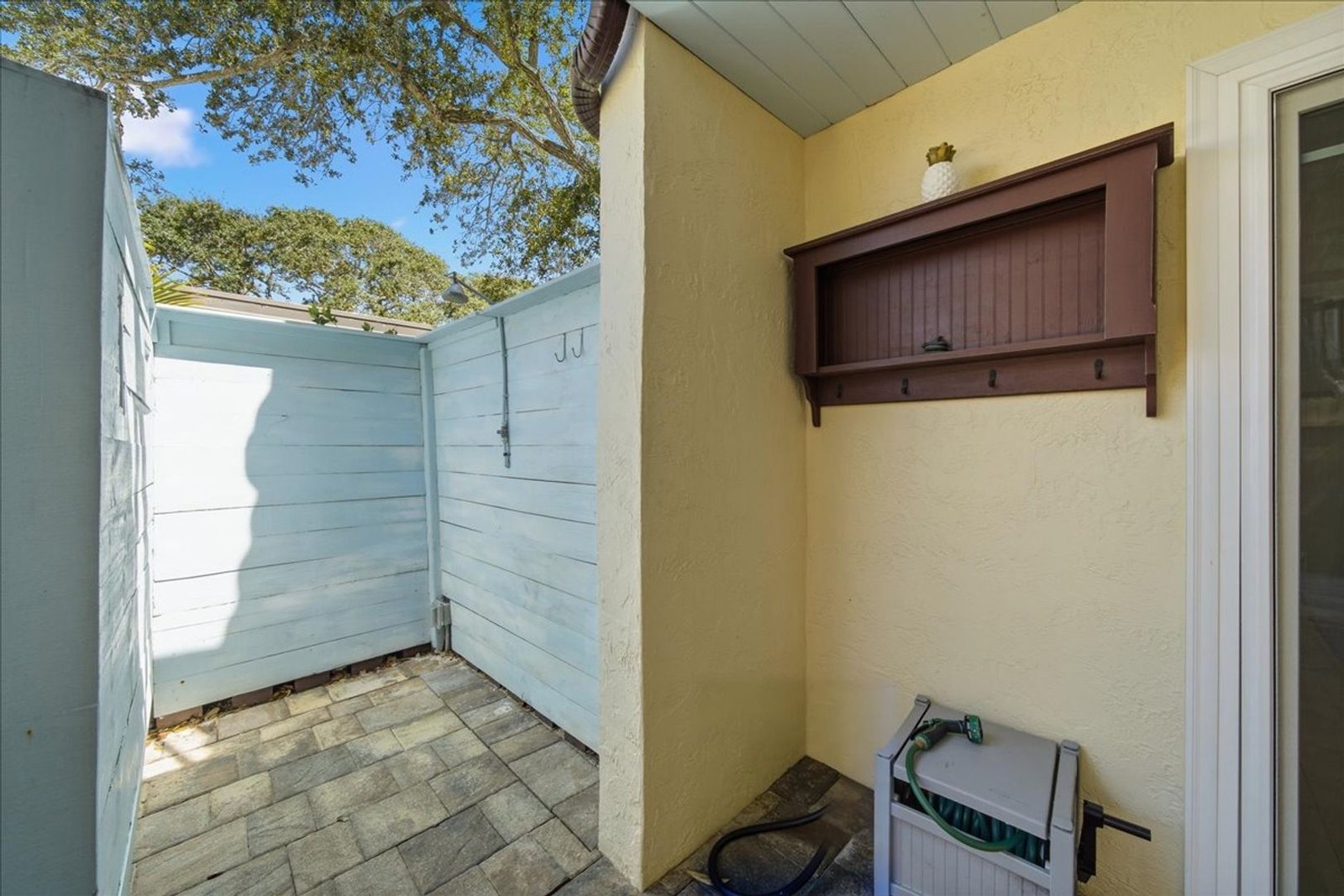 Private outdoor shower and patio storage at 8760 Live Oak Ct