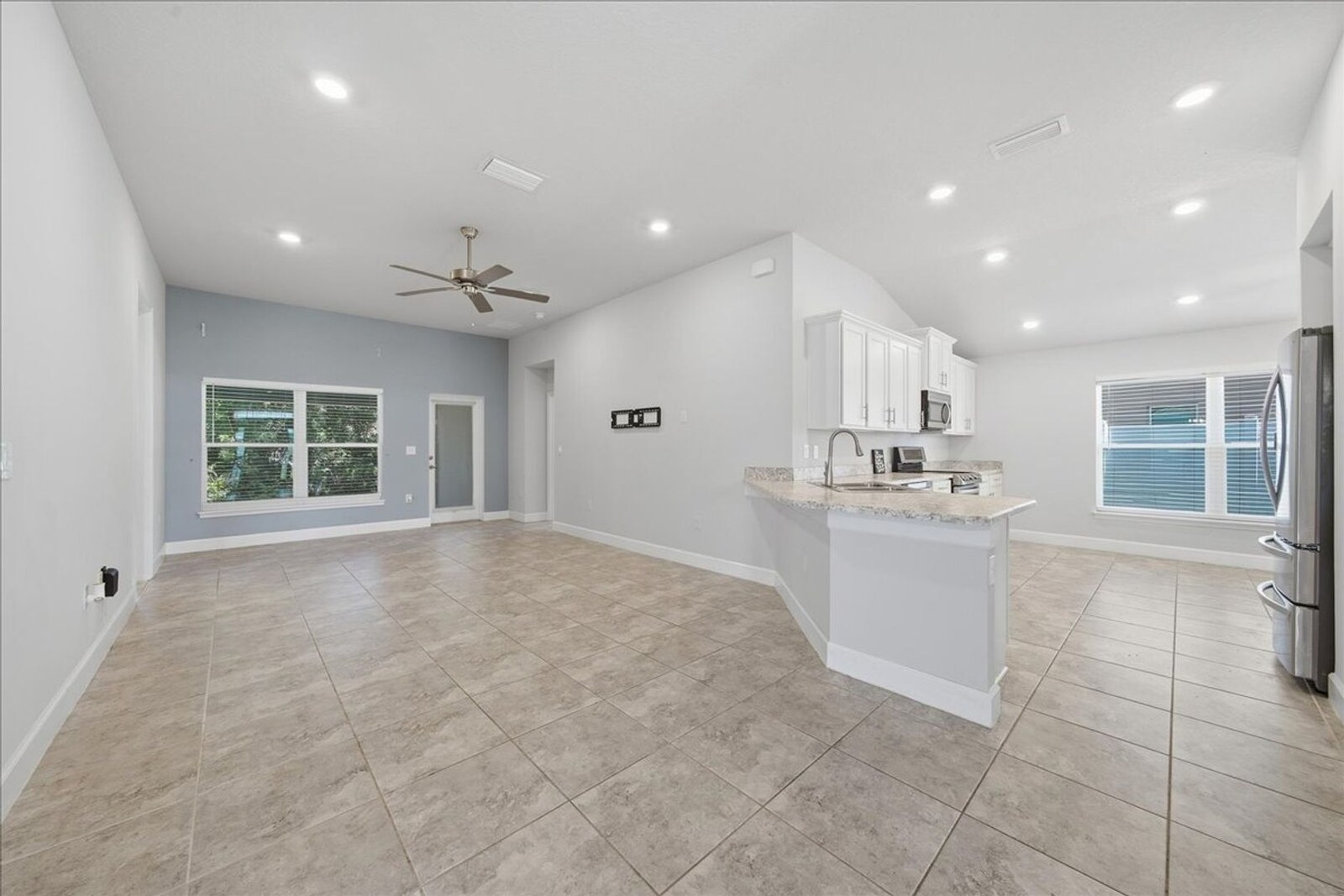 Open family room and kitchen with breakfast bar at 1261 Tupelo Cir
