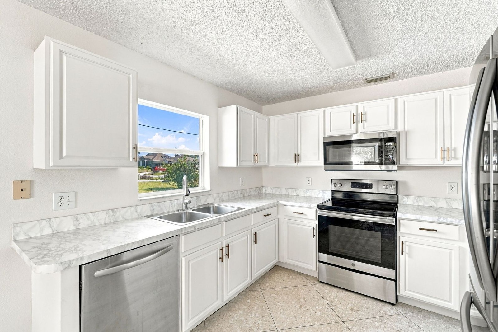 Kitchen sink window, dishwasher, and stainless range at 707 Merrimac St SE