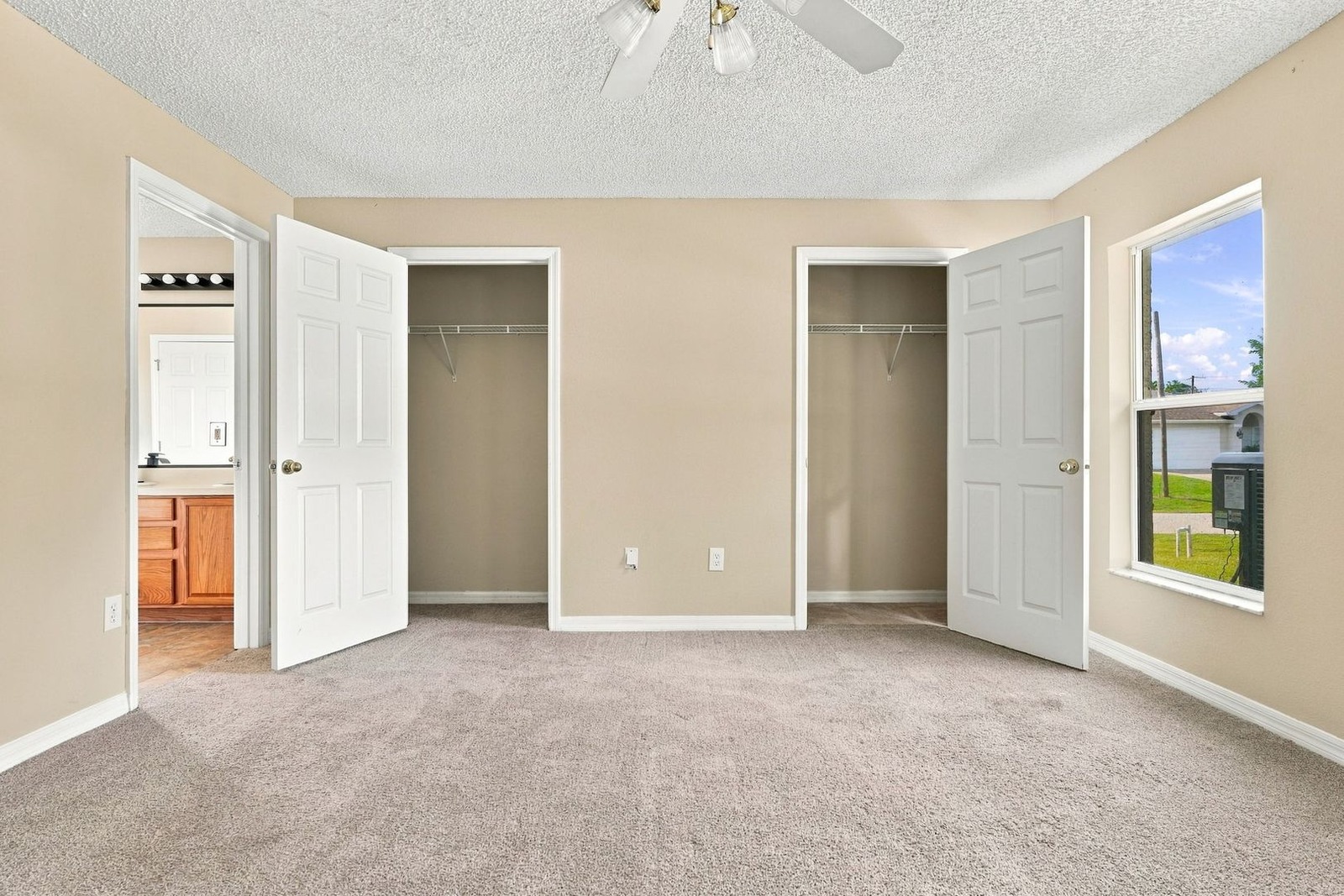 Primary bedroom with two closets and bath entry at 707 Merrimac St SE
