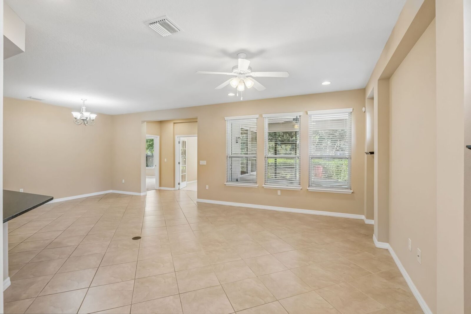 Great room with ceiling fan and large-format tile at 374 Salt Marsh Ln