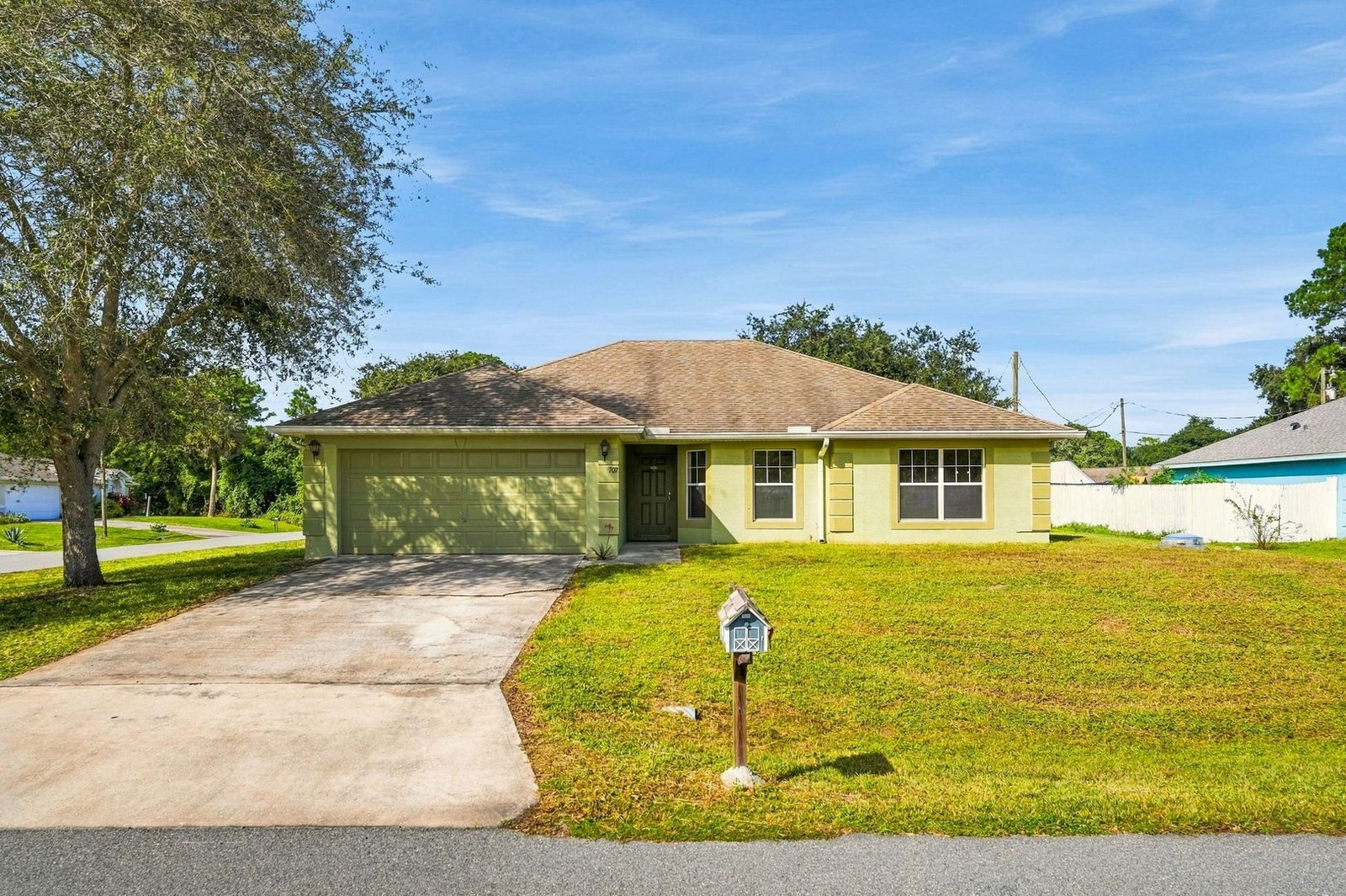Front exterior of 707 Merrimac St SE in Palm Bay with attached garage and wide driveway