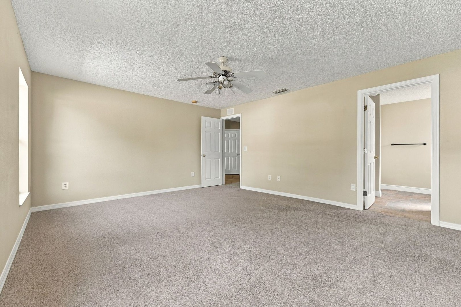 Primary bedroom looking toward the ensuite bath at 707 Merrimac St SE
