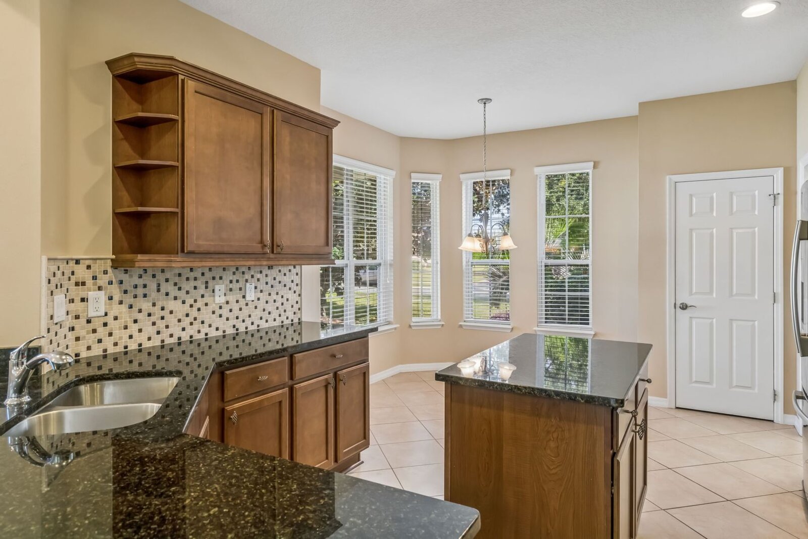Kitchen with bay window and tile backsplash at 374 Salt Marsh Ln