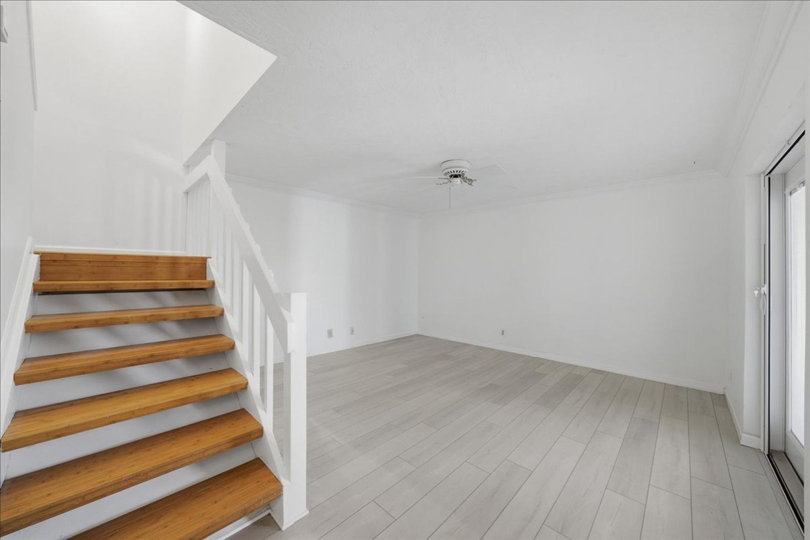 Wood staircase to the upstairs bedrooms at 8760 Live Oak Ct