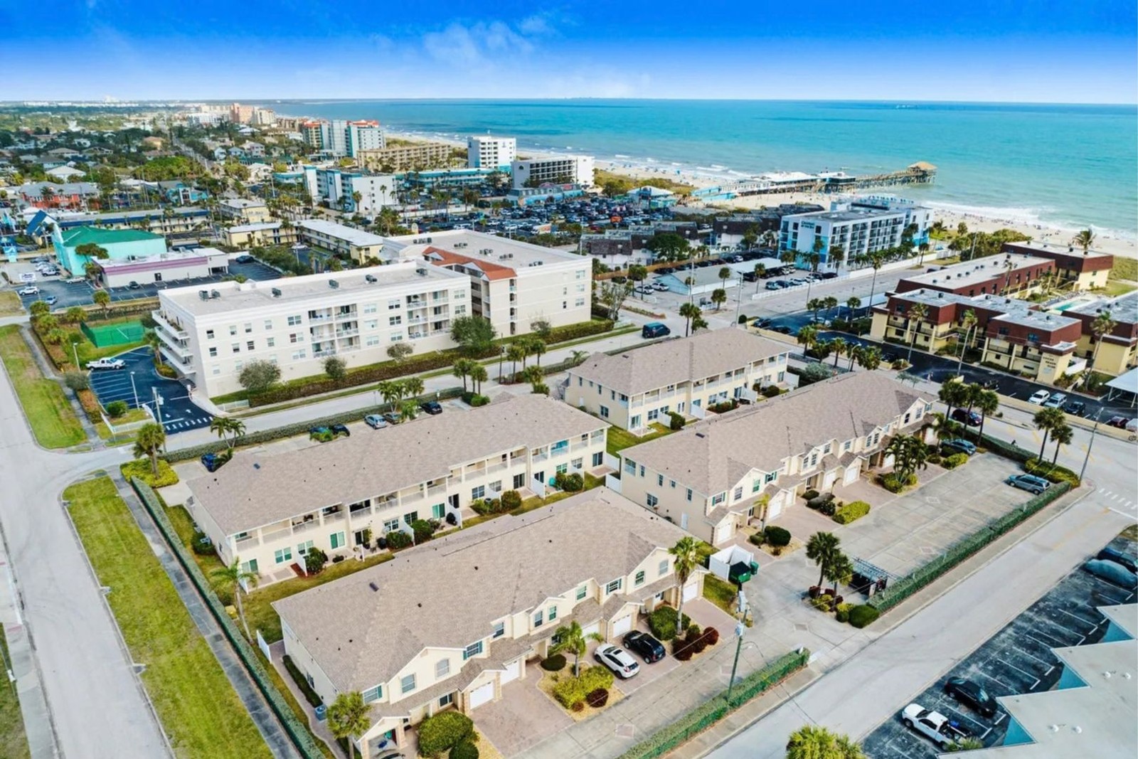 Aerial view of the community, the ocean, and the Cocoa Beach Pier