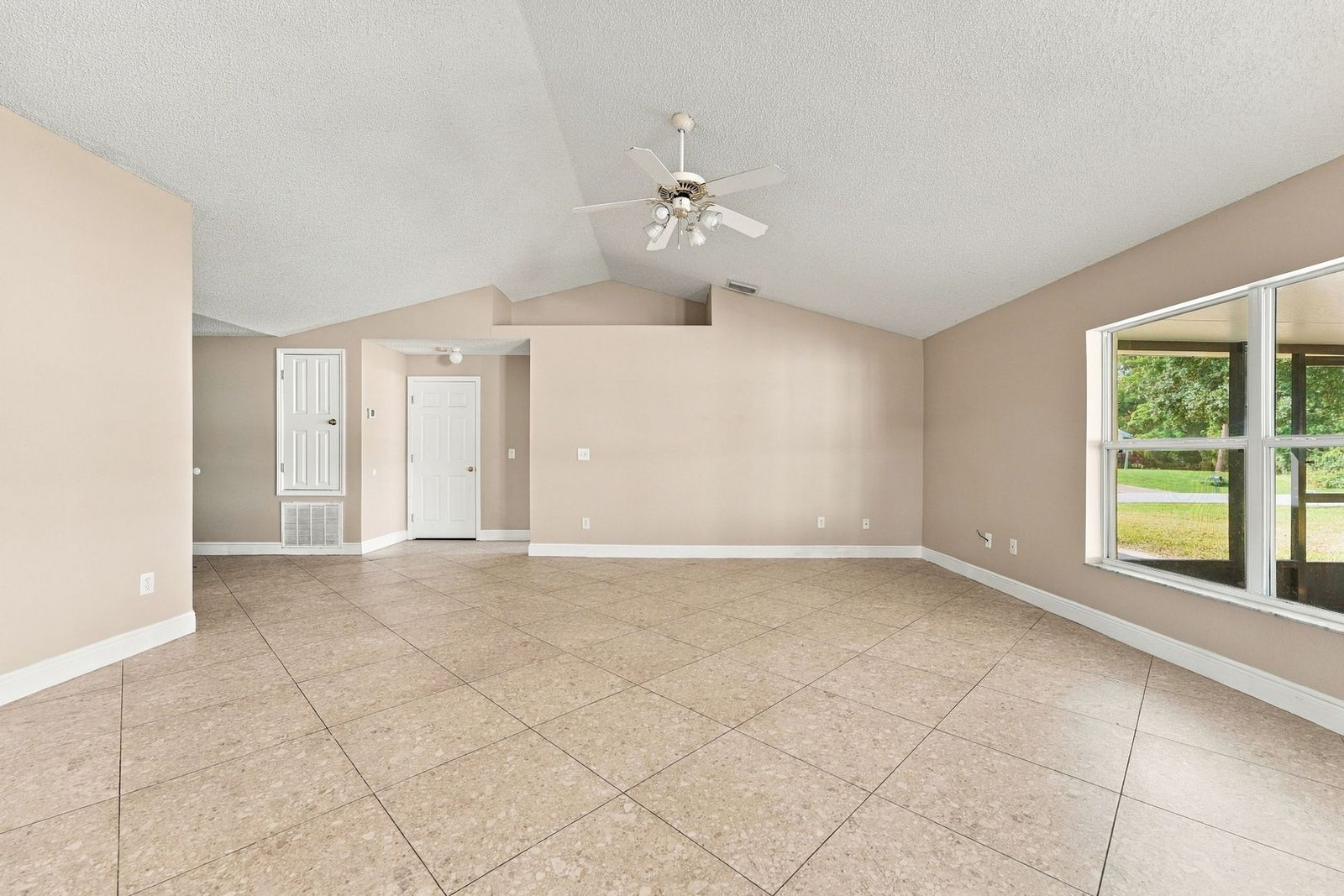 Open great room with vaulted ceilings and front door at 707 Merrimac St SE