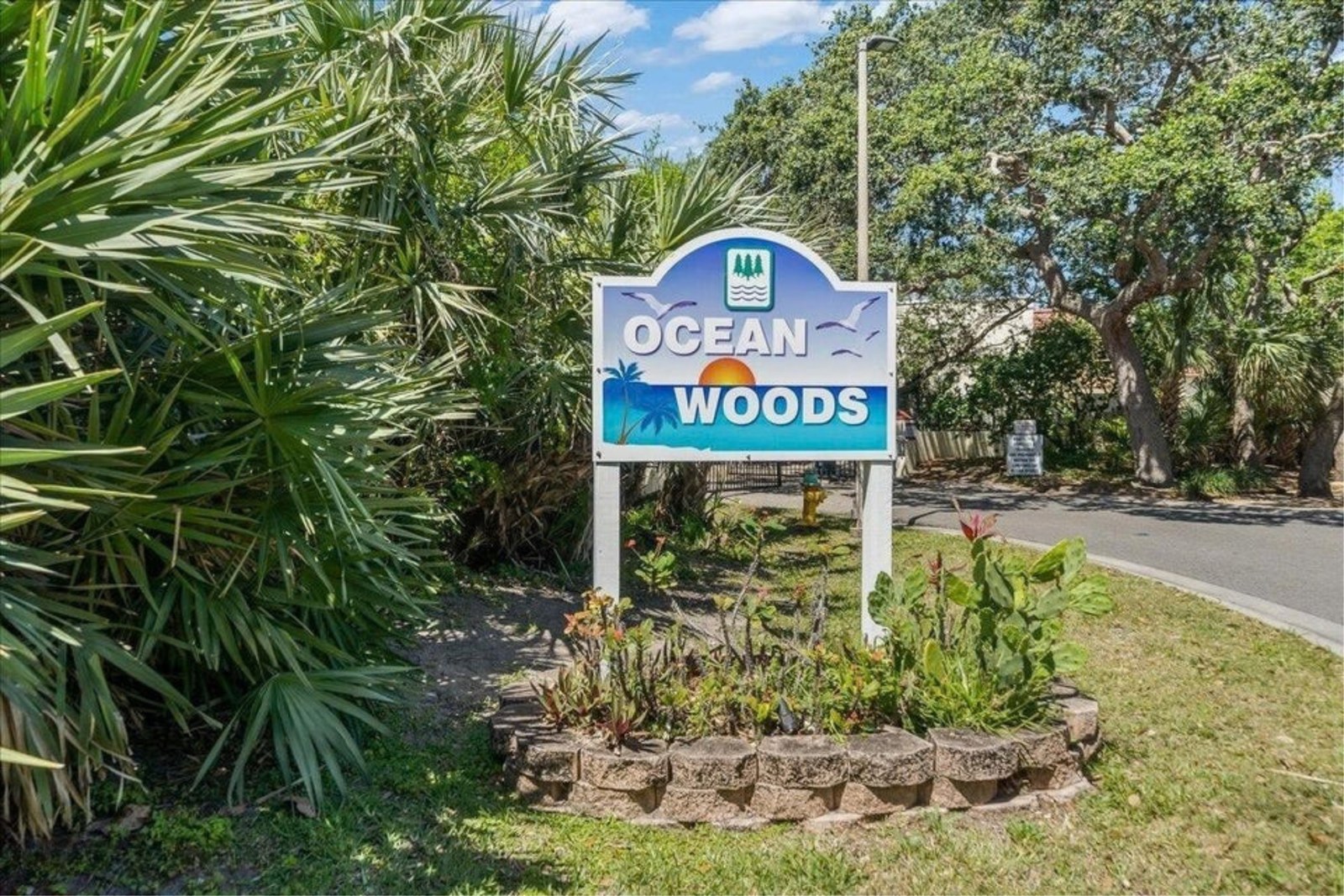 Ocean Woods community sign among the palms in Cape Canaveral