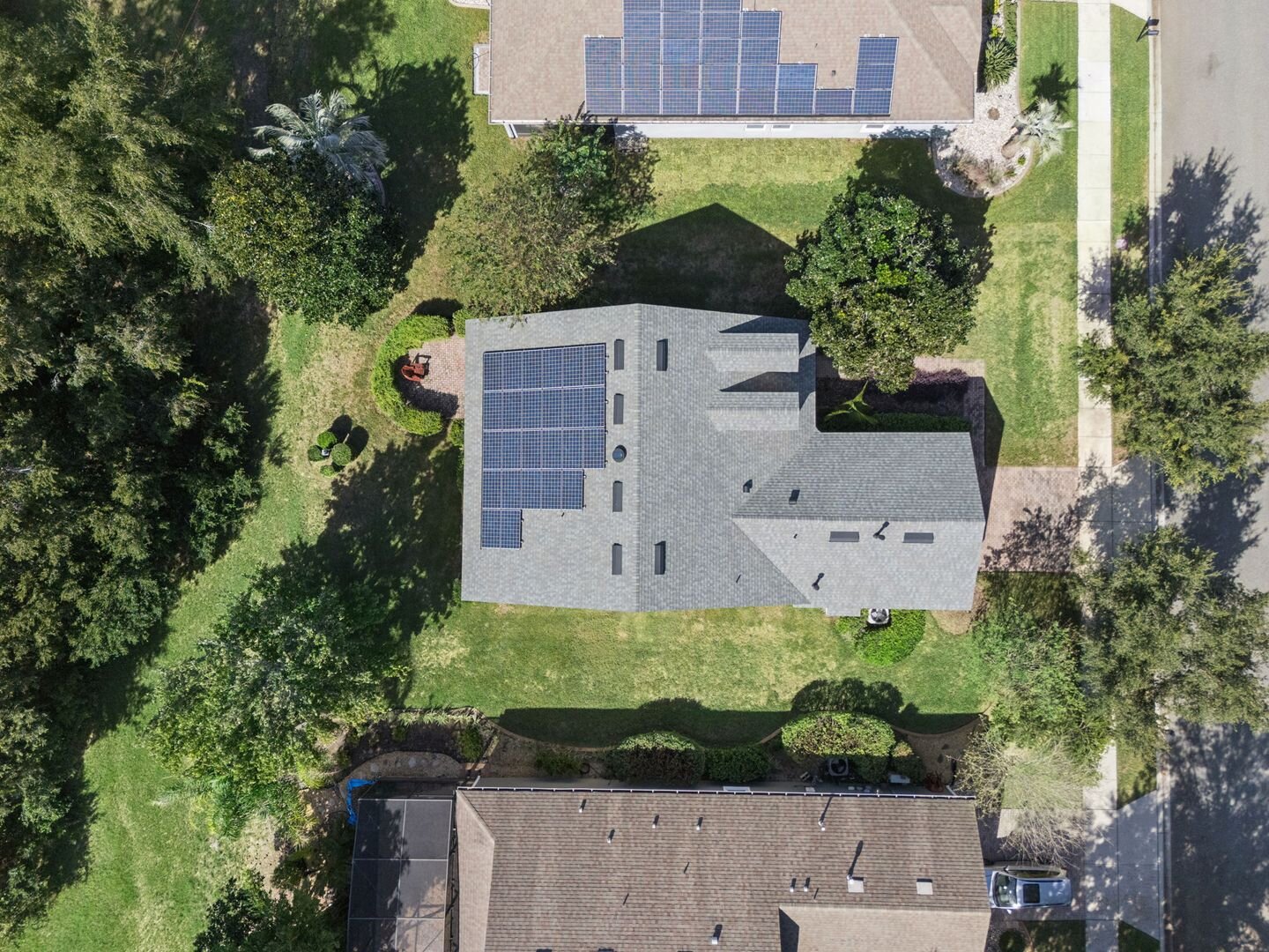 Aerial view of 374 Salt Marsh Ln showing the roof and solar panels