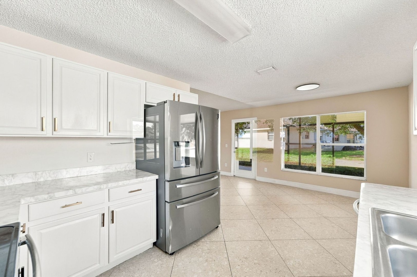 Kitchen with French-door refrigerator looking toward the eat-in area at 707 Merrimac St SE