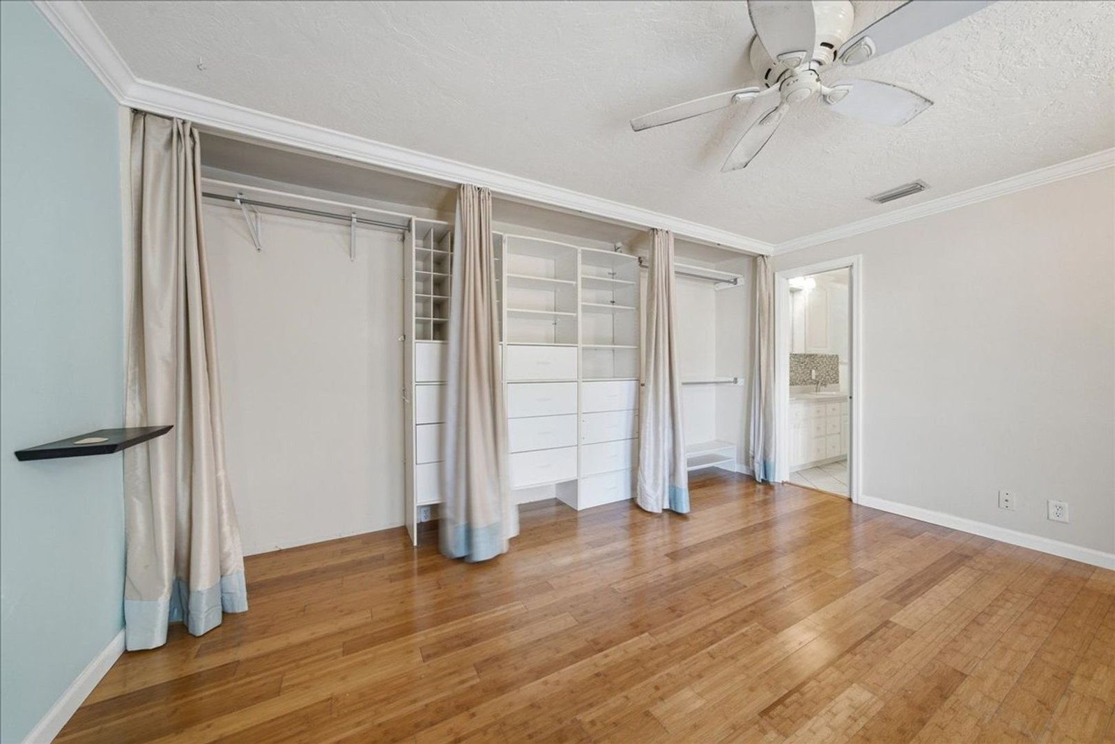 Bedroom with built-in storage and balcony access