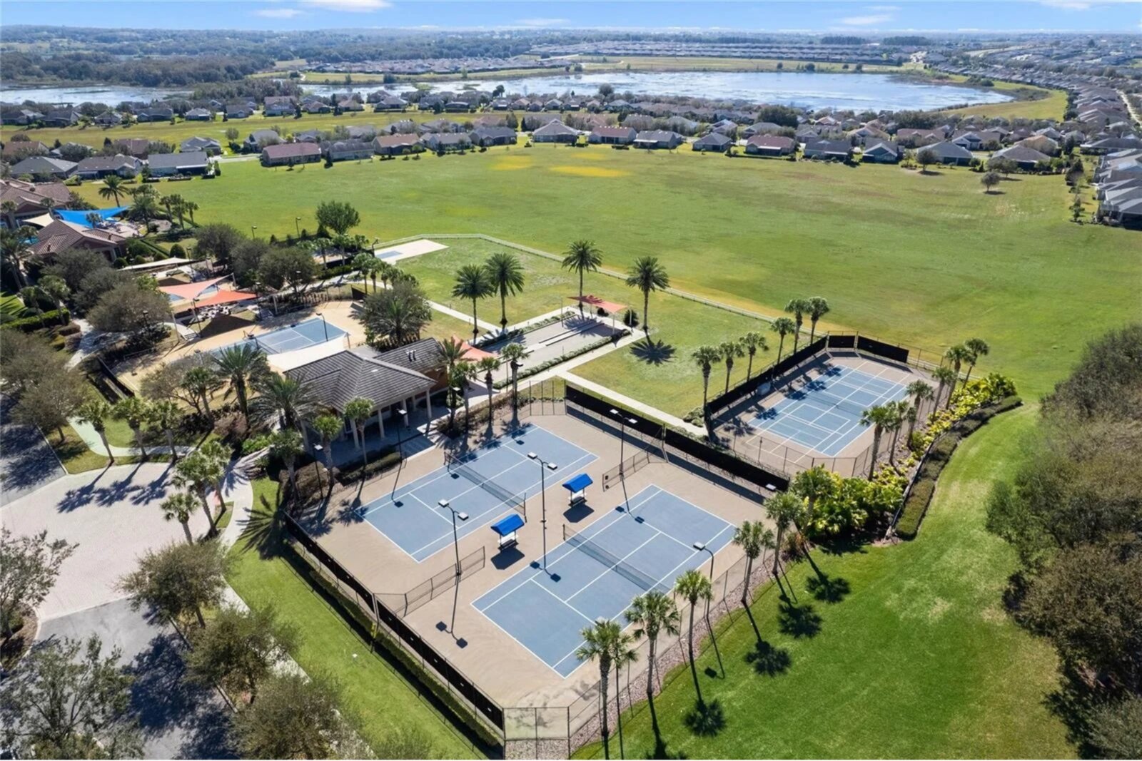 Aerial view of the Trilogy Orlando clubhouse, pool, and courts
