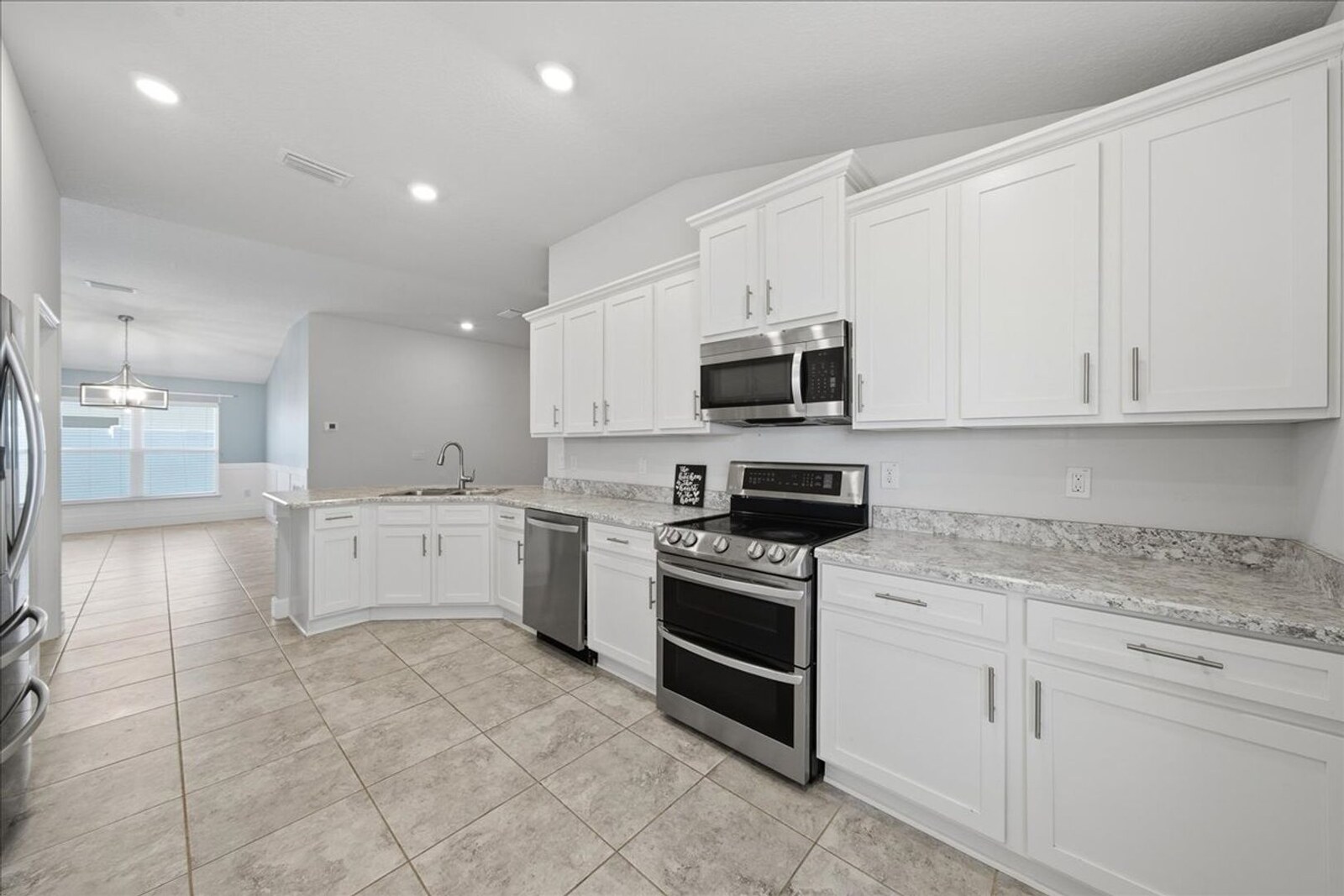 Kitchen with white cabinets and stainless steel appliances at 1261 Tupelo Cir