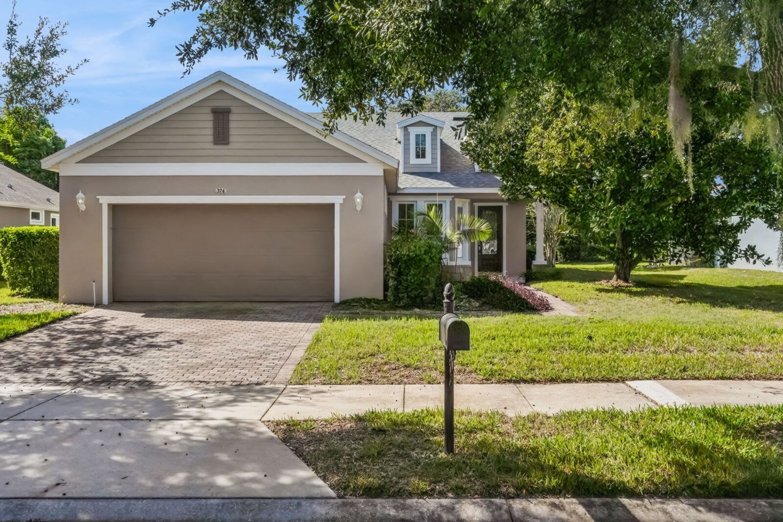 Front exterior and driveway of 374 Salt Marsh Ln from the street