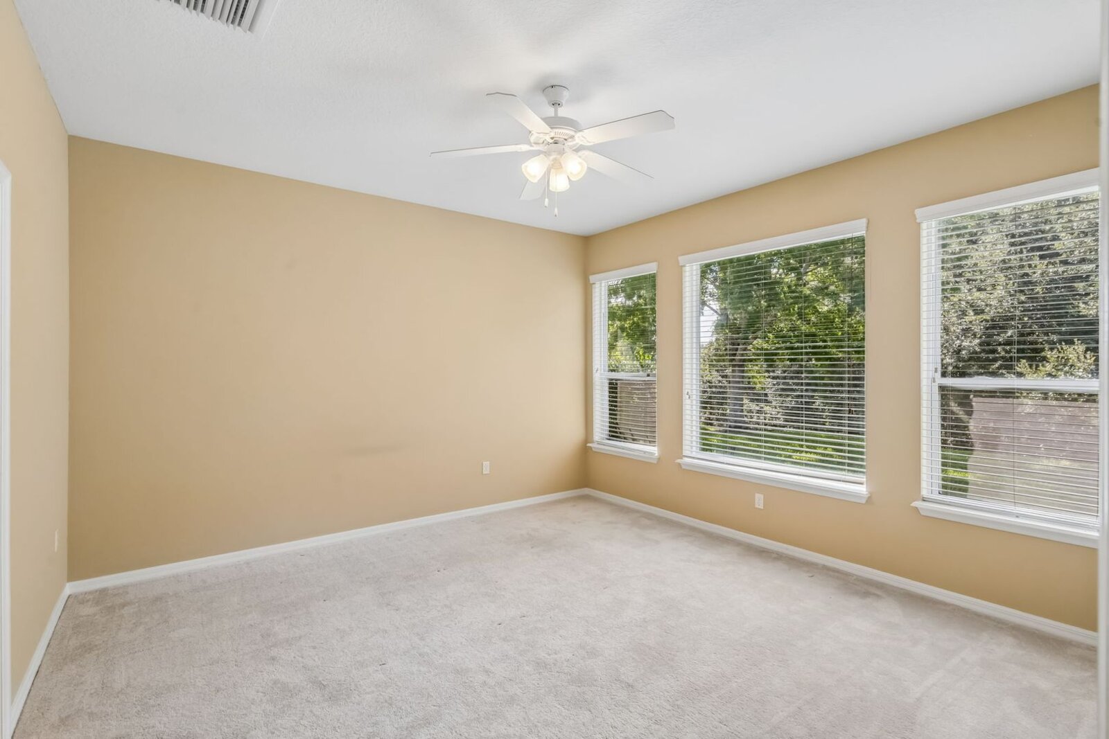 Primary bedroom with ceiling fan and windows at 374 Salt Marsh Ln