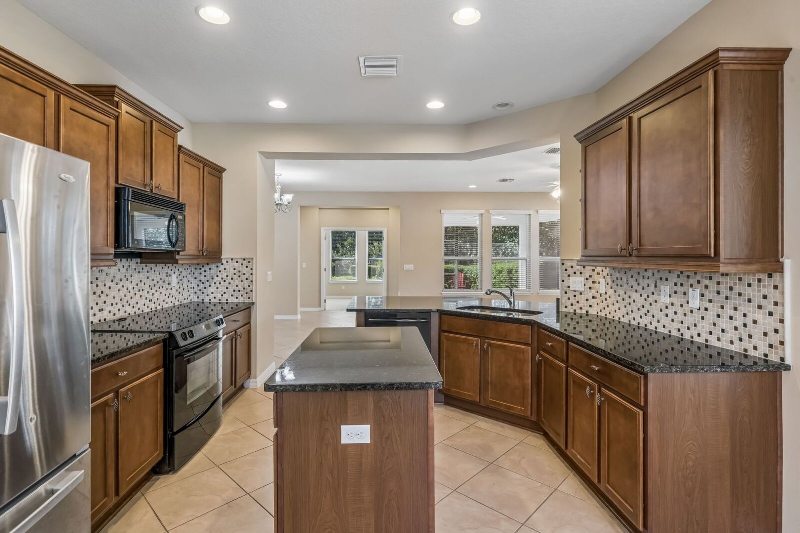 Kitchen with island, granite counters, and stainless appliances at 374 Salt Marsh Ln