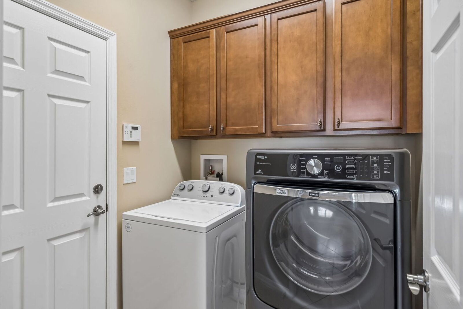 Laundry room with washer, dryer, and cabinets at 374 Salt Marsh Ln