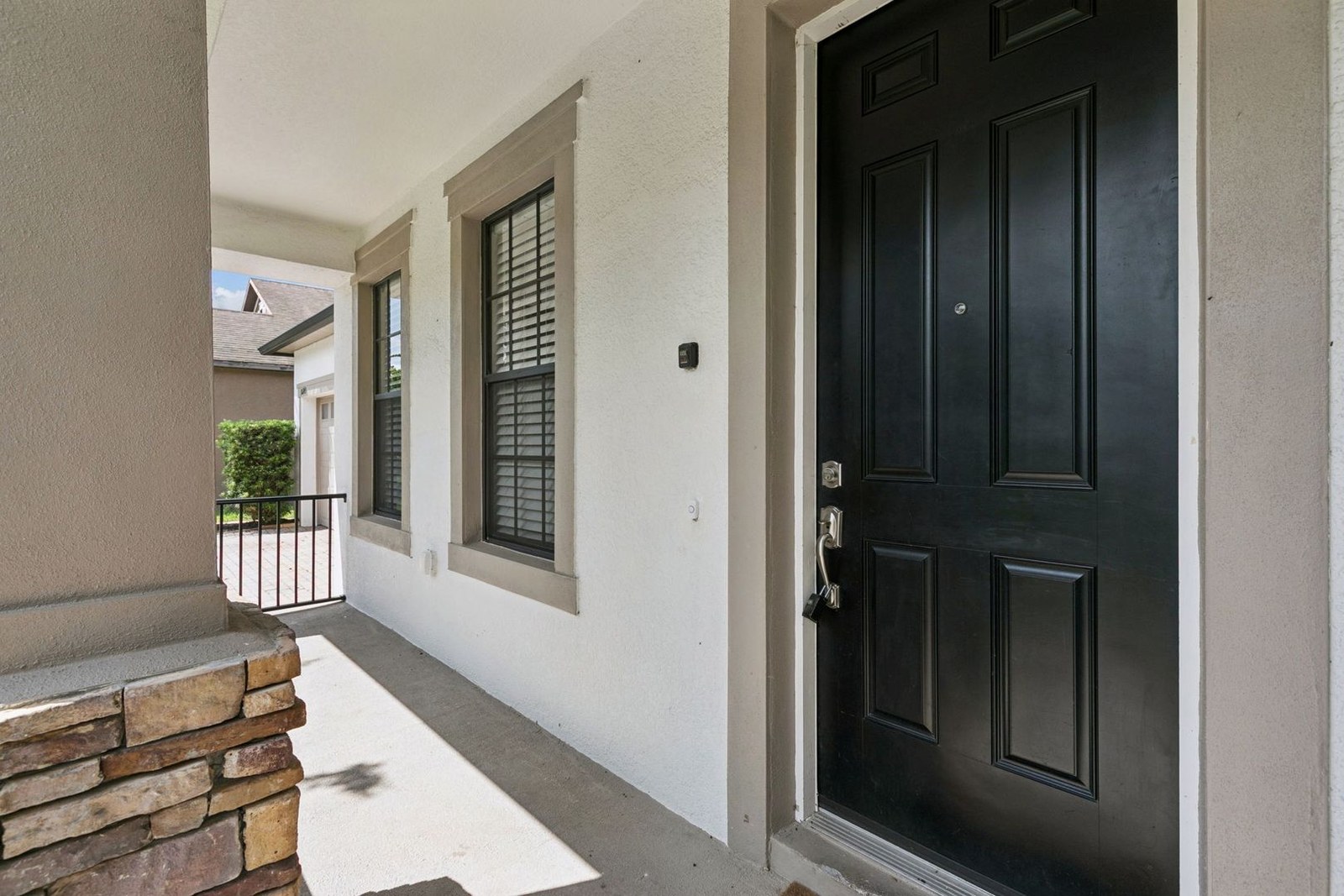 Covered front entry and stone-accent columns at 10249 Park Row Ct