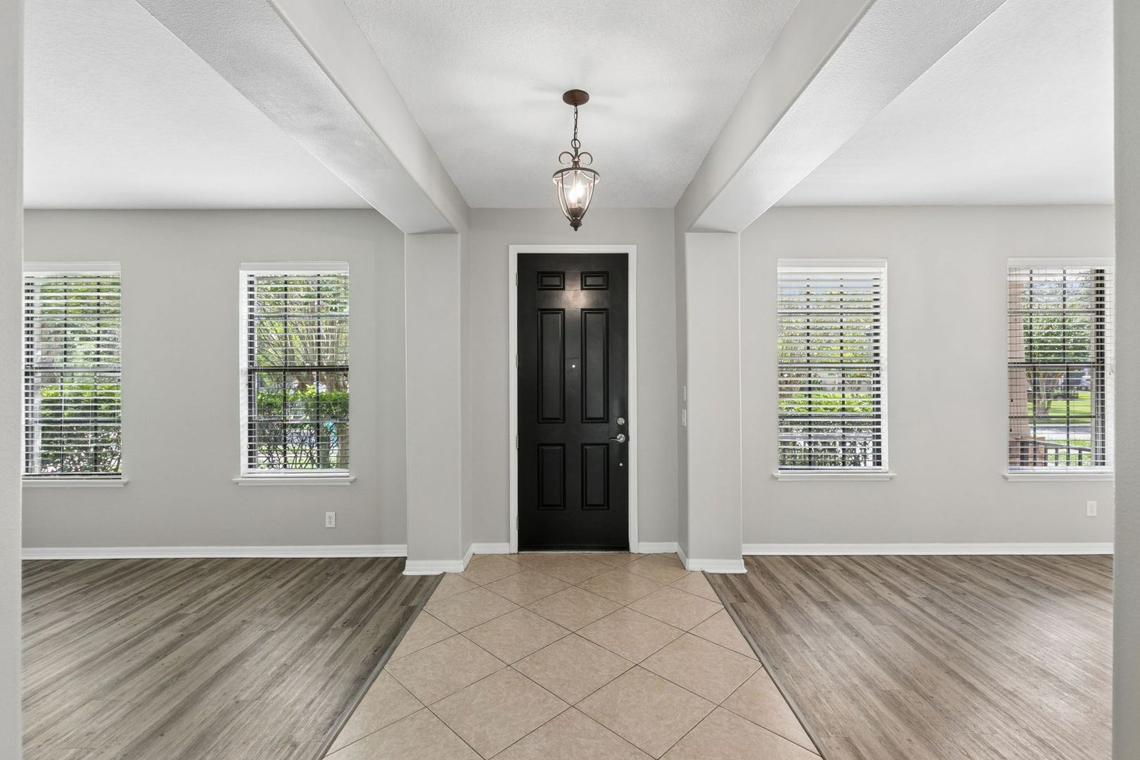 Foyer with plantation shutters and formal living and dining rooms at 10249 Park Row Ct