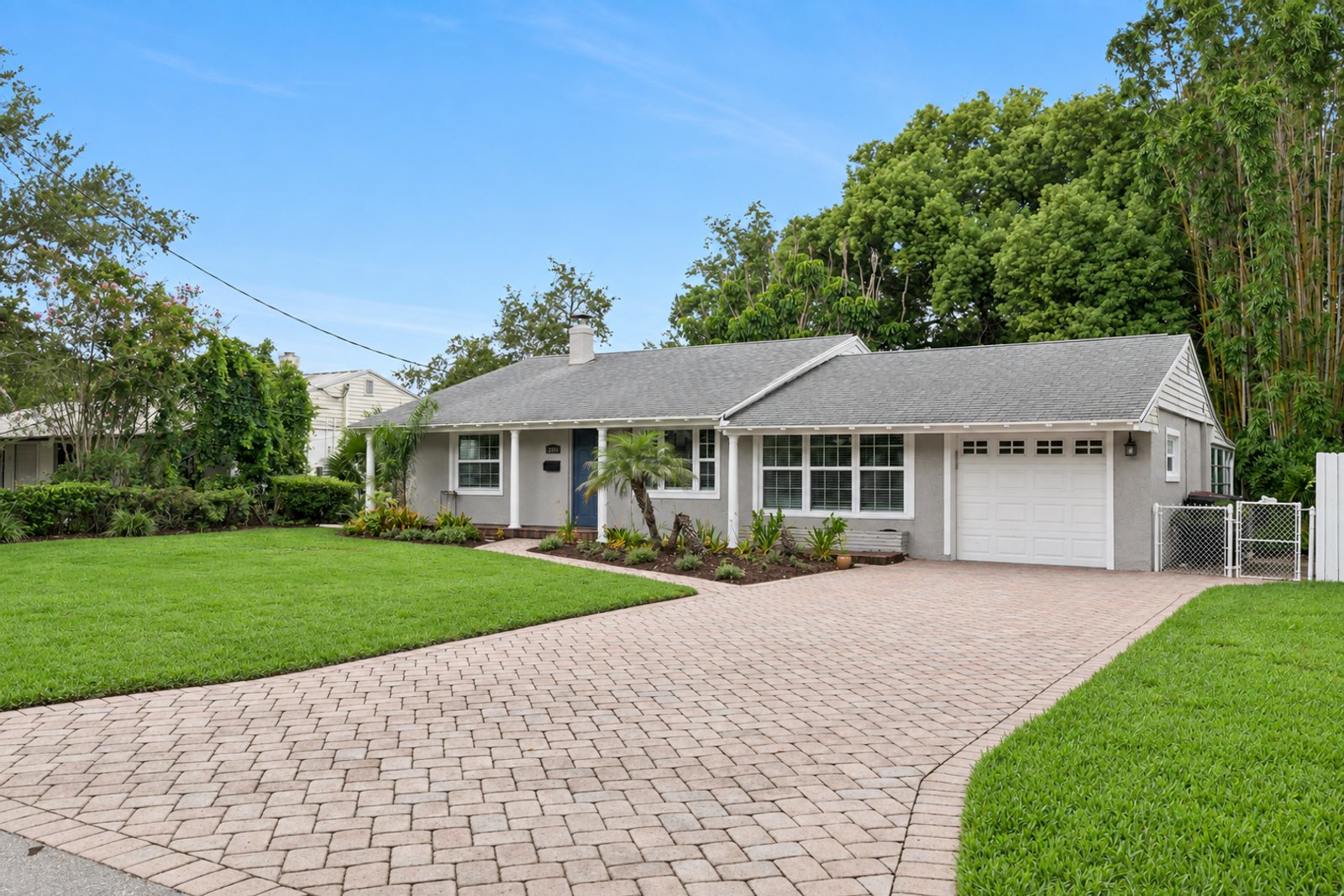 Extra-long paver driveway leading to the attached one-car garage at 3306 Eagle Blvd