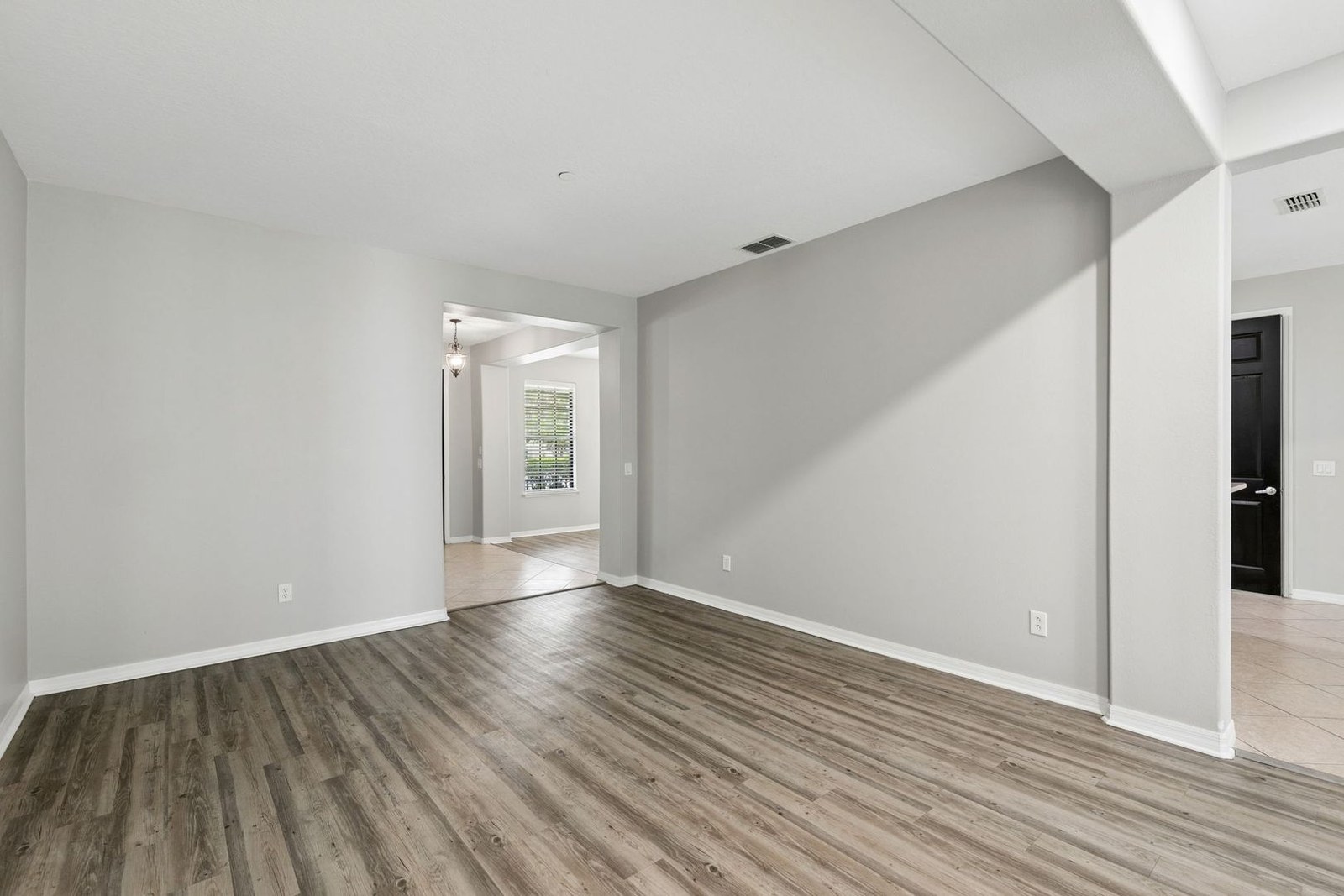 Formal living room or den with wood-look flooring