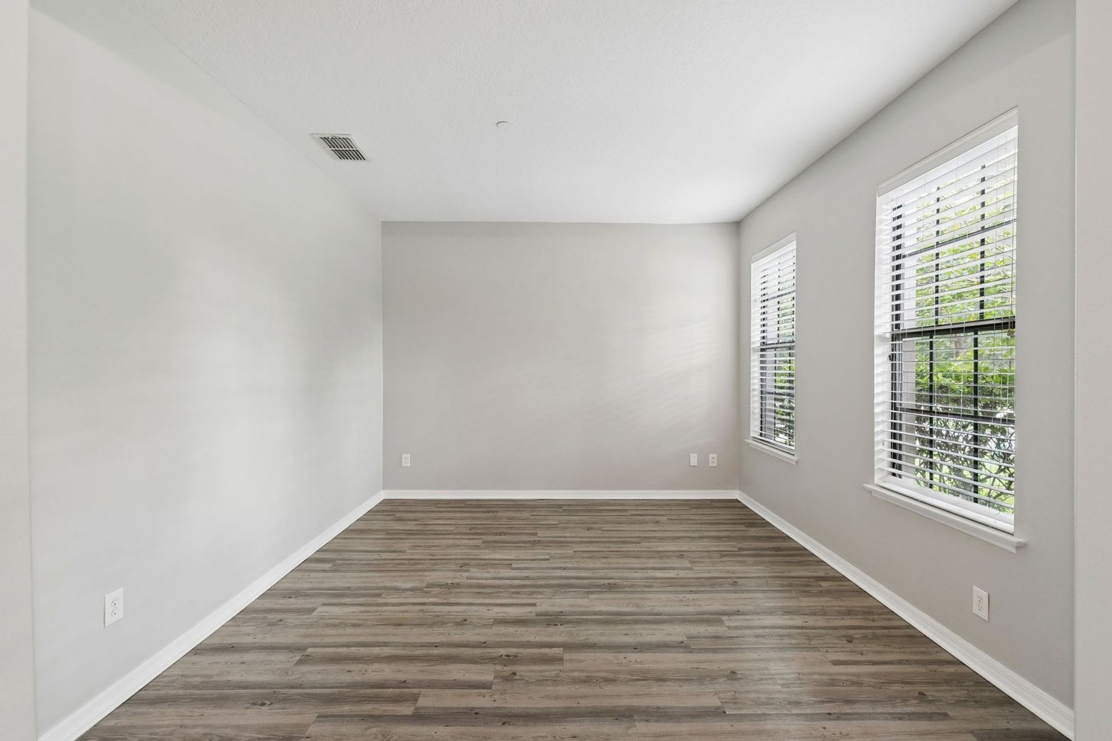 Den with plantation-shuttered windows at 10249 Park Row Ct