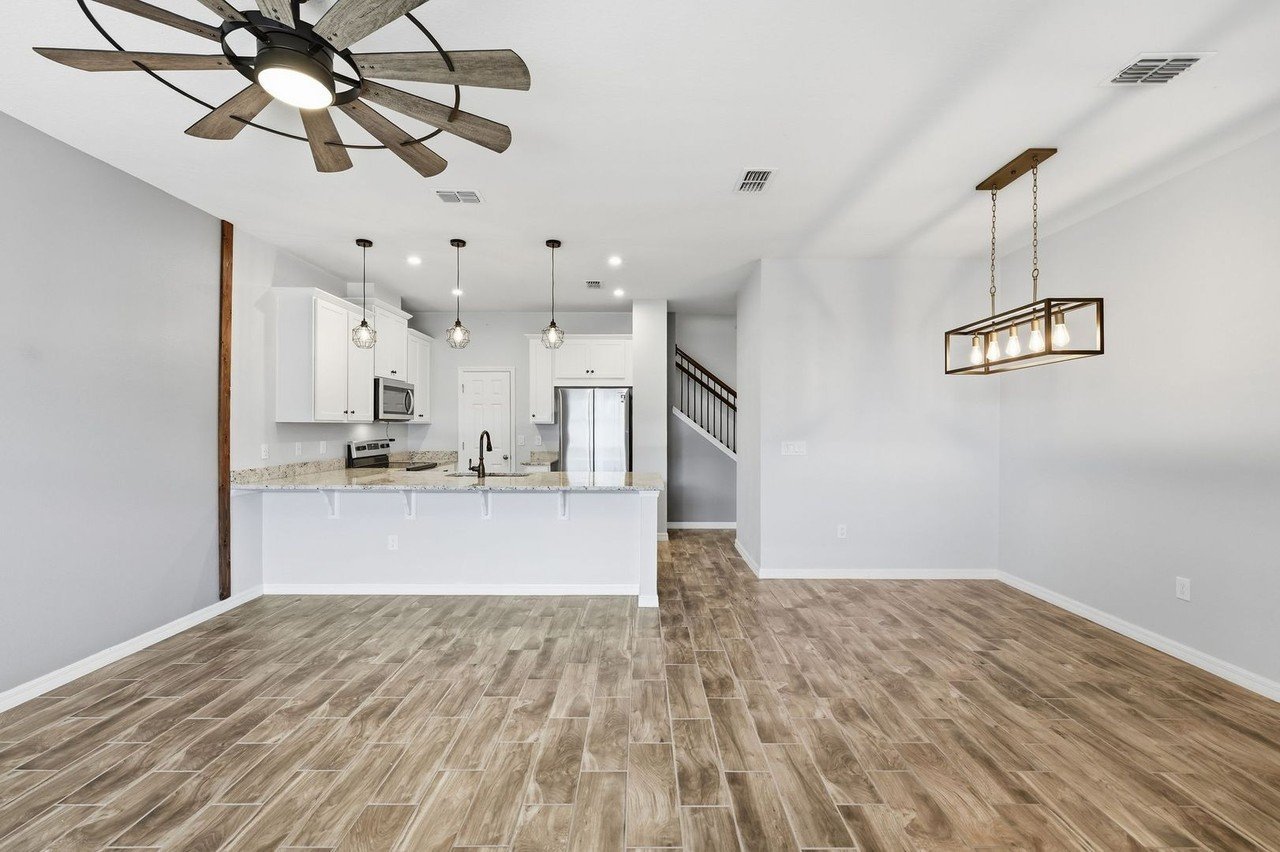 Open-concept living area and kitchen with island at 2946 Firebush Way