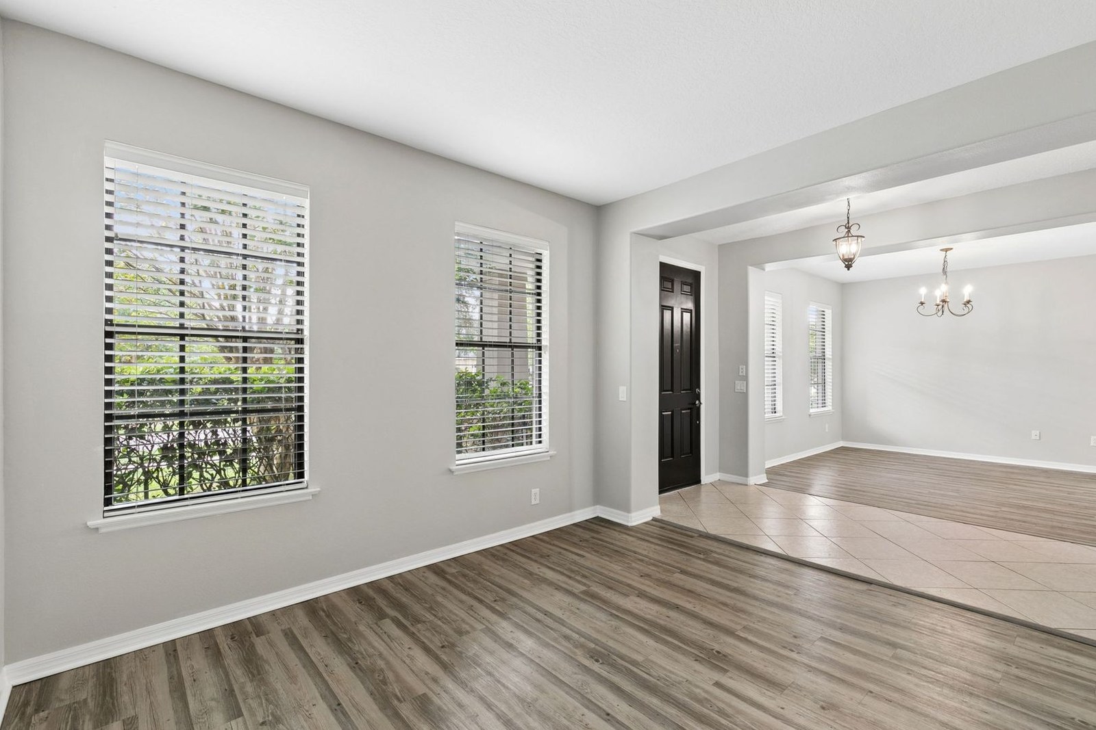 Formal dining room with chandelier and plantation shutters