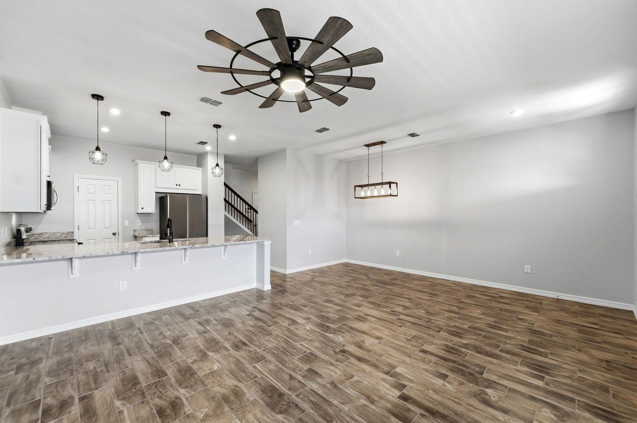 Great room with tile flooring, recessed lighting, and ceiling fan