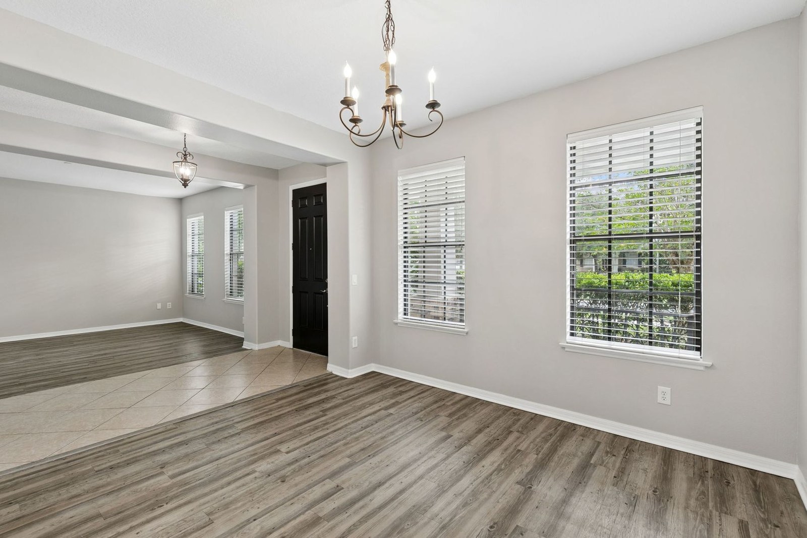 Dining or flex room with chandelier and wood-look floors