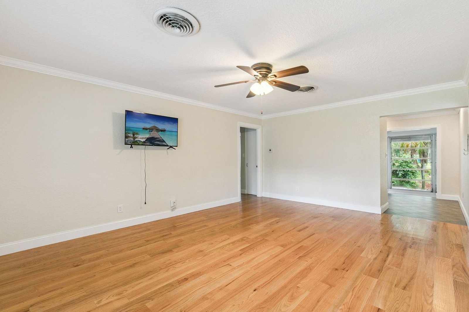 Living room with hardwood floors, ceiling fan, and natural light at 3306 Eagle Blvd