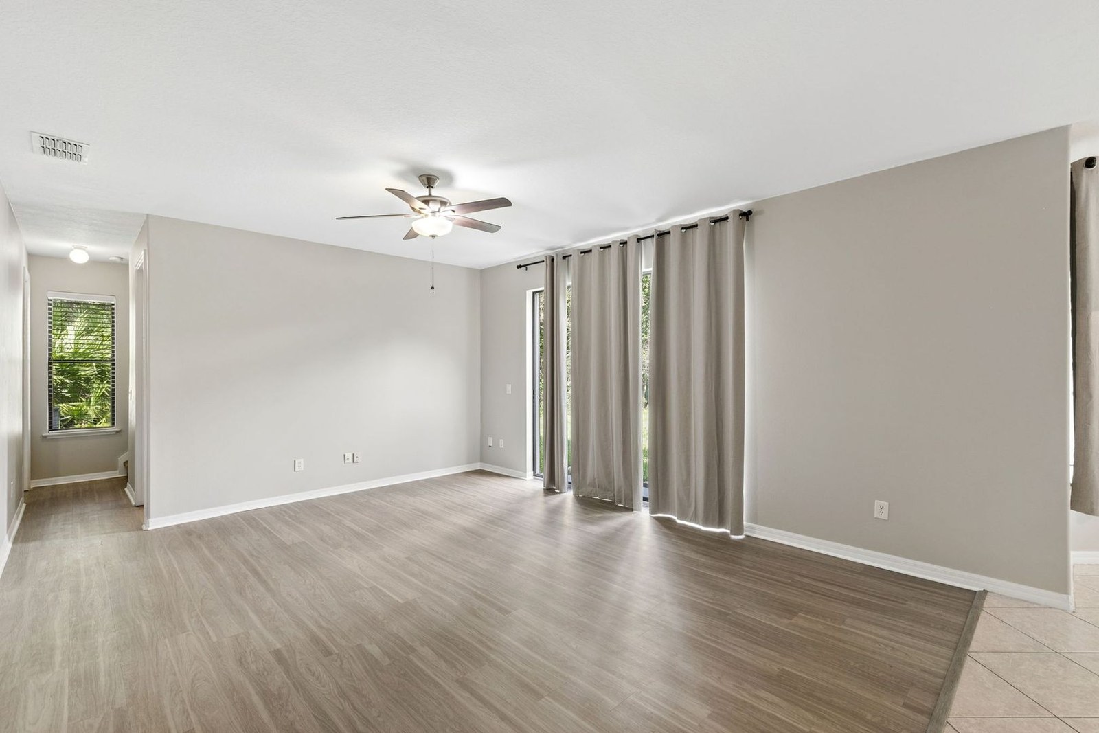 Family room with ceiling fan and sliding doors to the lanai at 10249 Park Row Ct