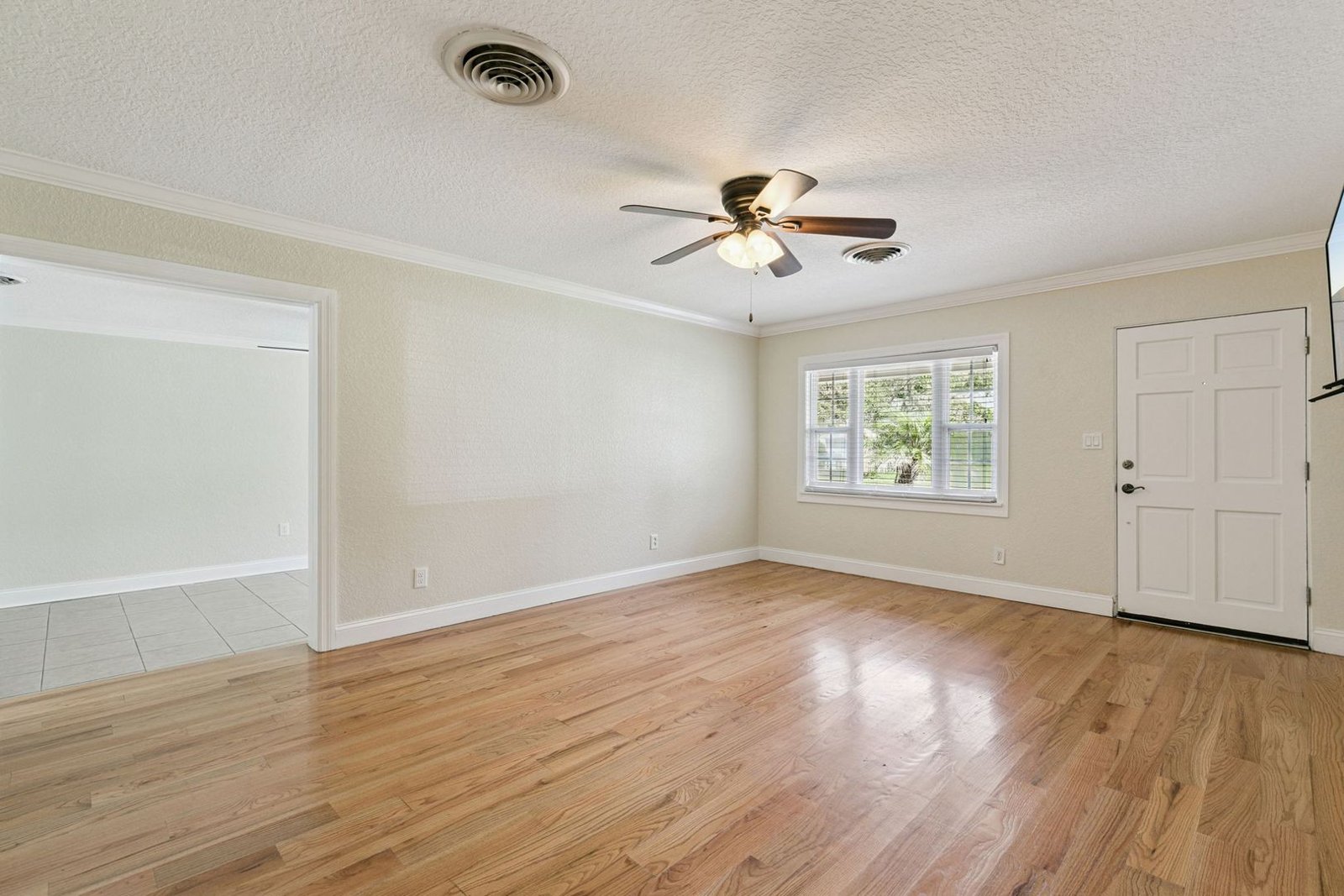 Bright living room with hardwood floors and front-facing windows