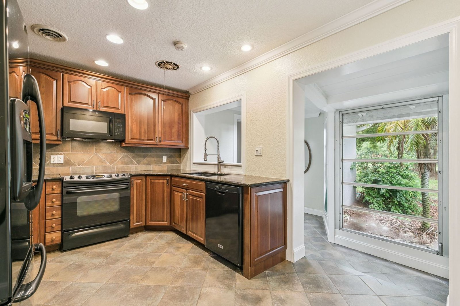 Kitchen pass-through with deep double-basin sink and commercial-style sprayer