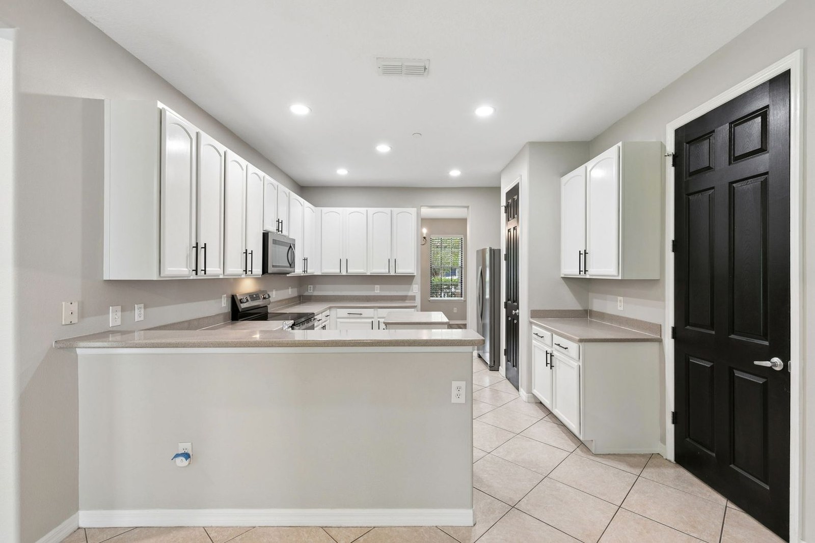 Kitchen with white cabinetry and stainless appliances at 10249 Park Row Ct