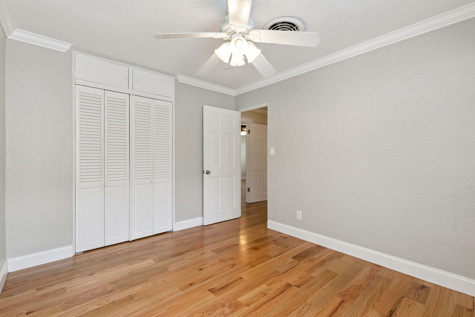 Primary bedroom with hardwood floors and closet at 3306 Eagle Blvd