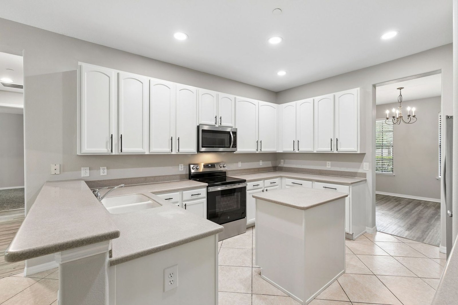 Kitchen island, stainless range, and microwave