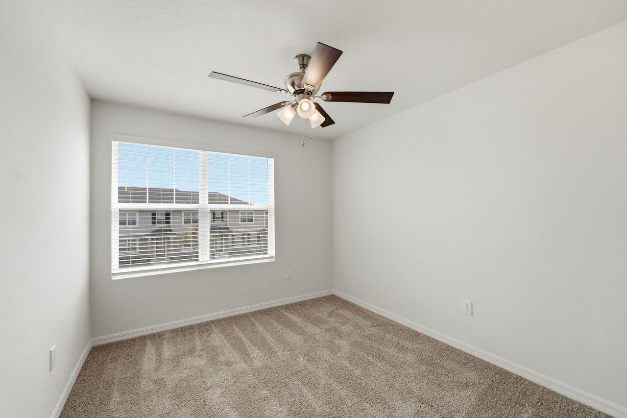 Second bedroom with carpet and window
