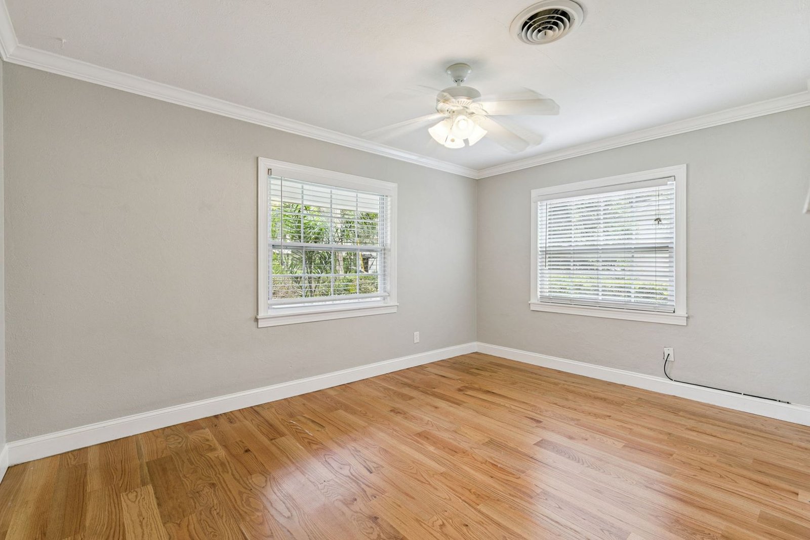 Third bedroom with hardwood floors and ceiling fan