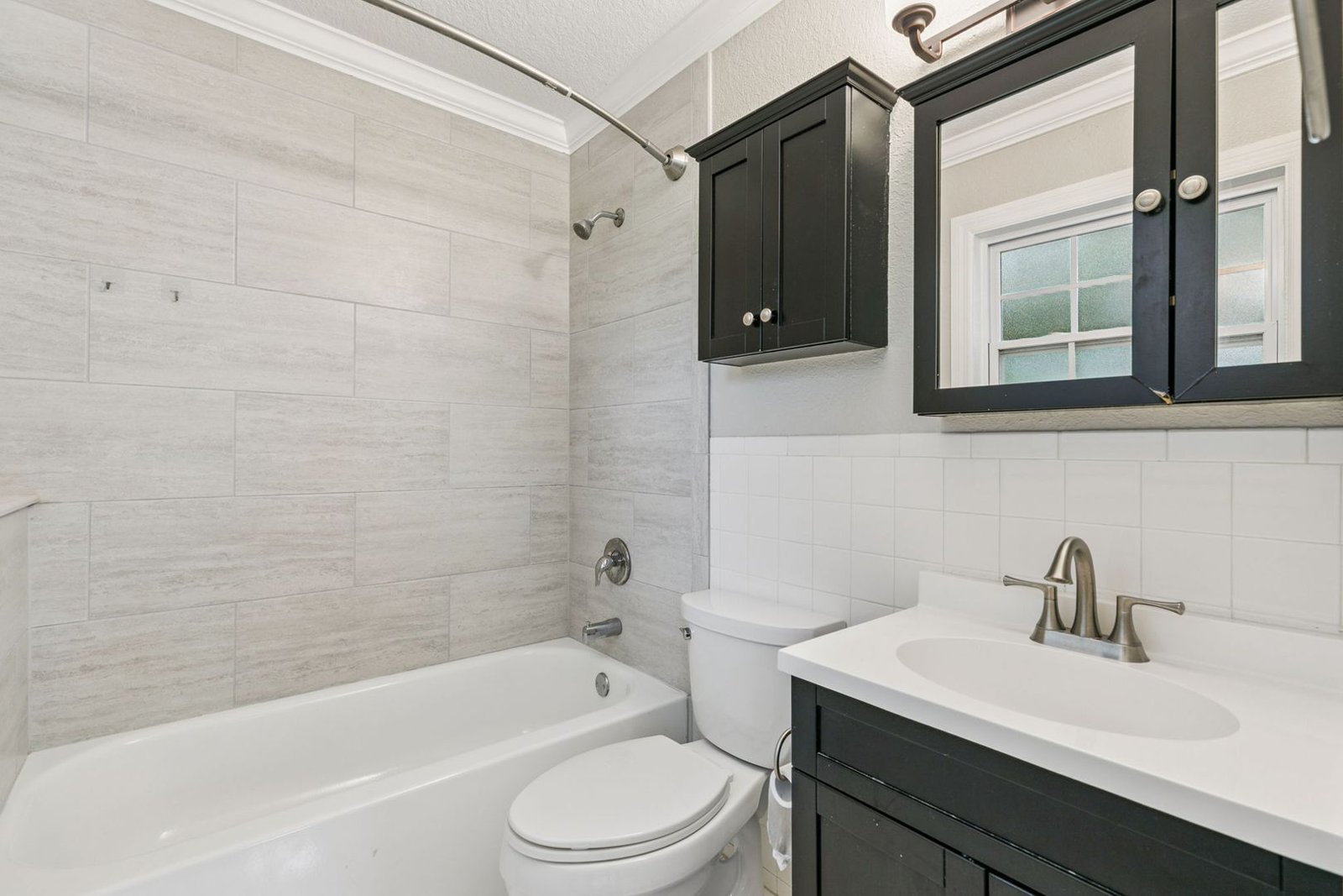 Second full bathroom with tub and updated vanity