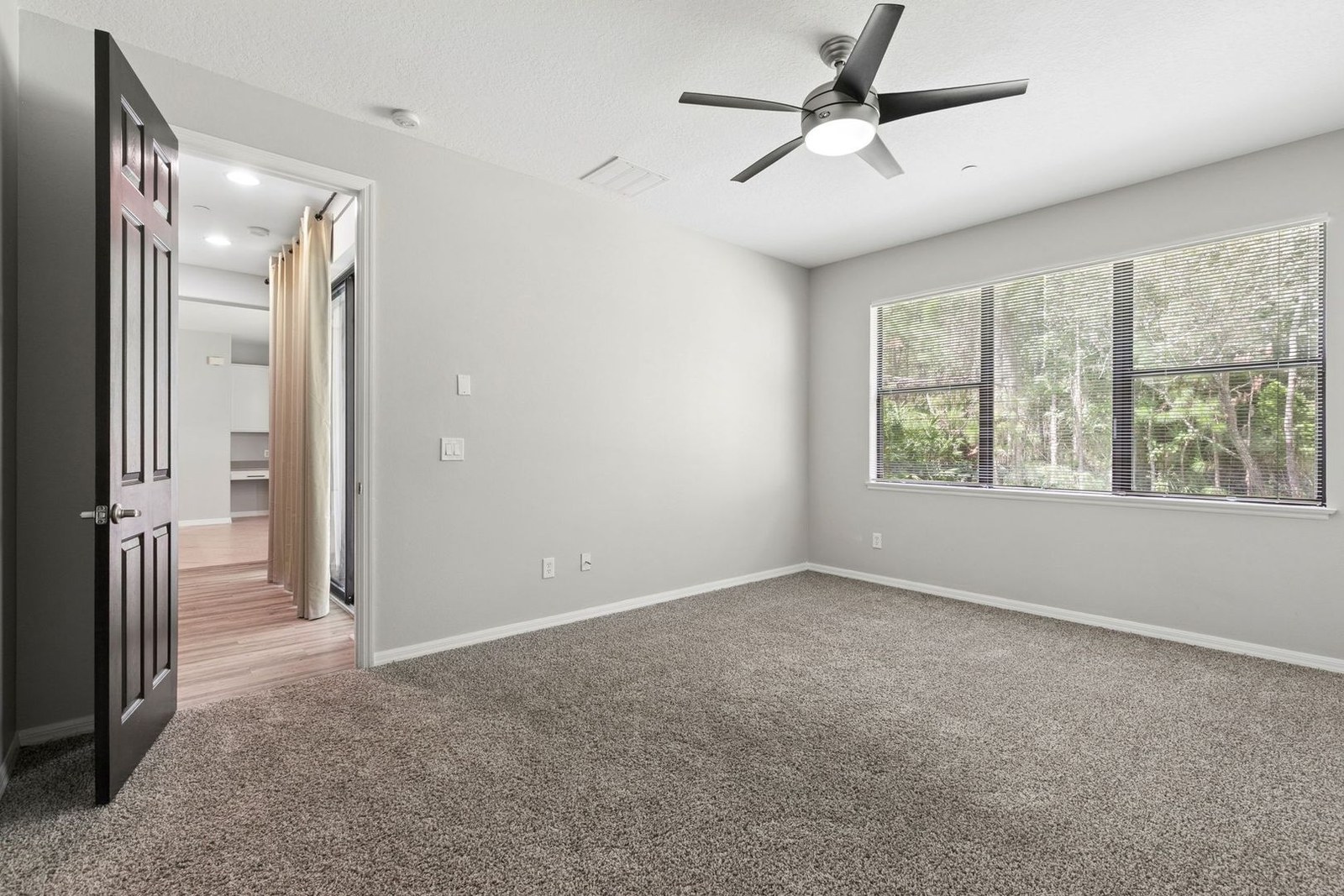 Primary suite with doors to the walk-in closet and bath