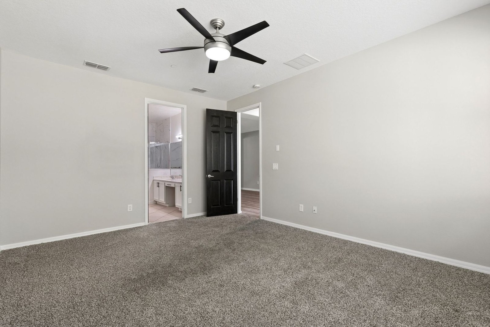 Second bedroom with carpet and ceiling fan