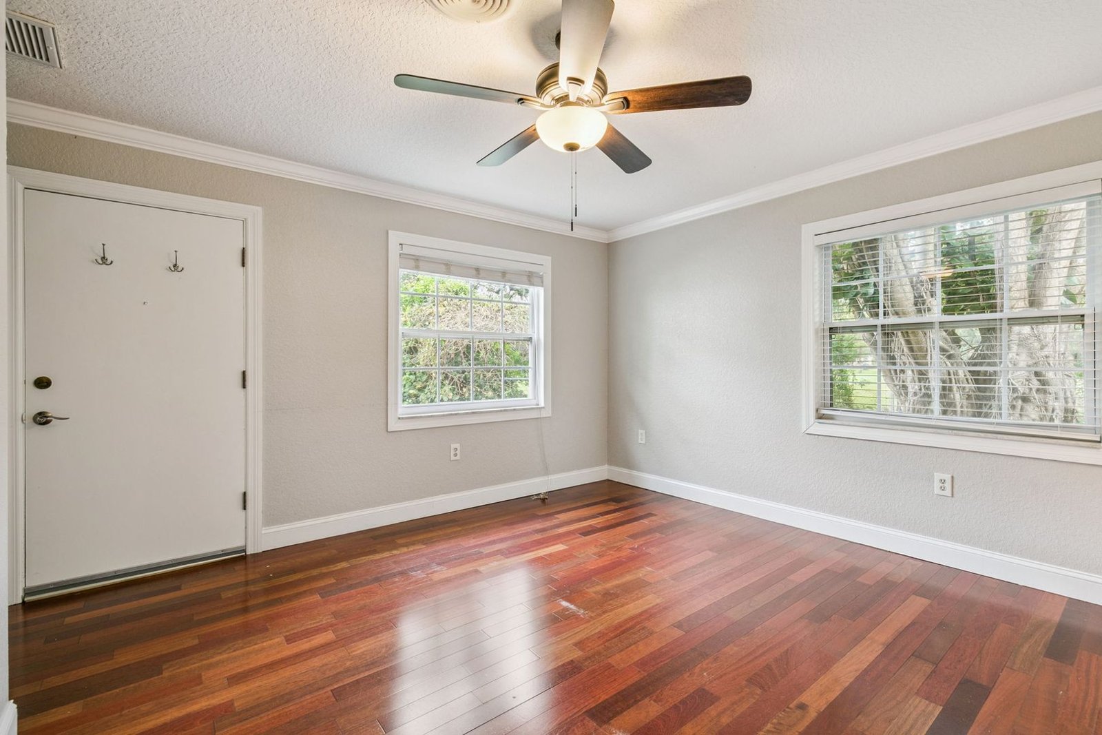 Bright bedroom with window and hardwood floors