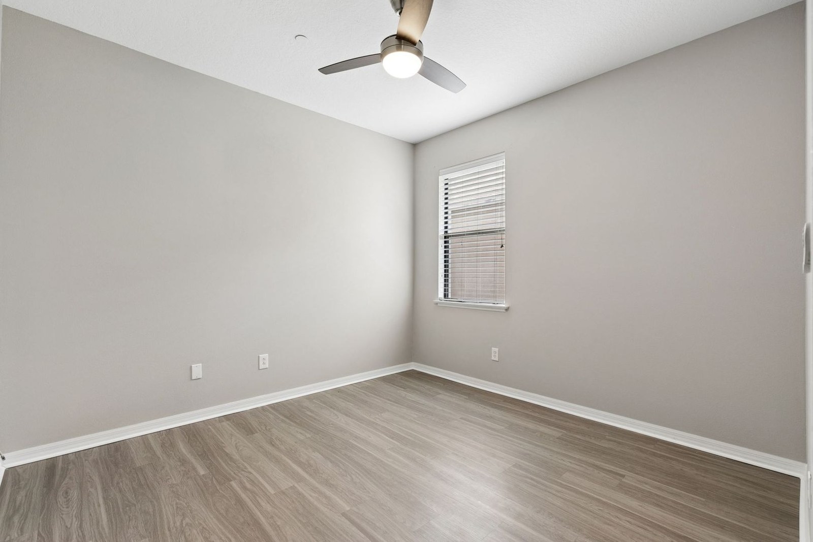 Bedroom with window and wood-look flooring