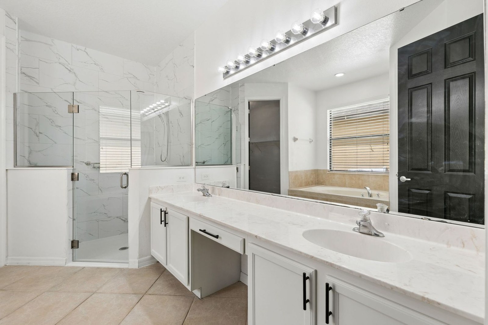 Primary bath with dual vanities and remodeled glass walk-in shower