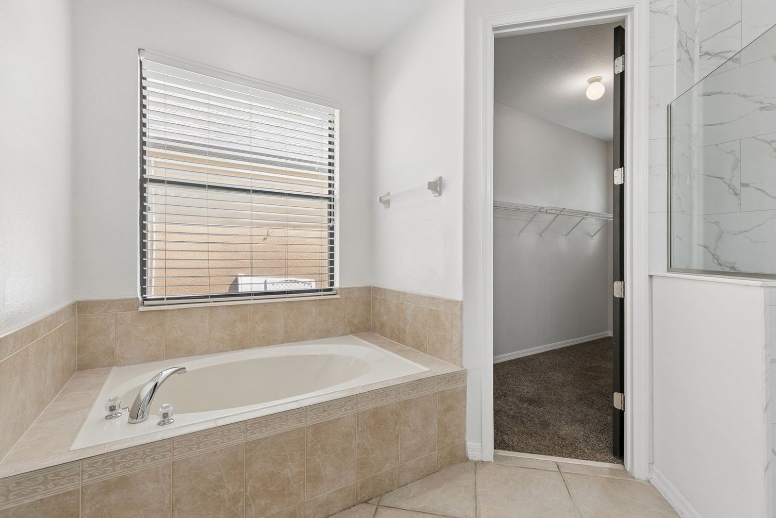 Garden tub and deep walk-in closet in the primary bath