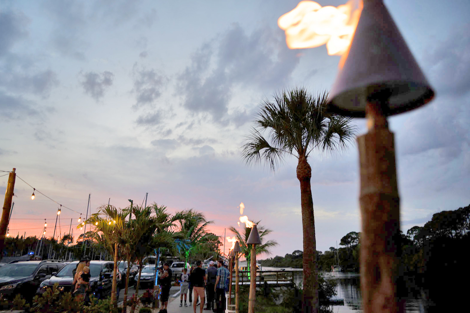 Tiki torches along the marina at sunset